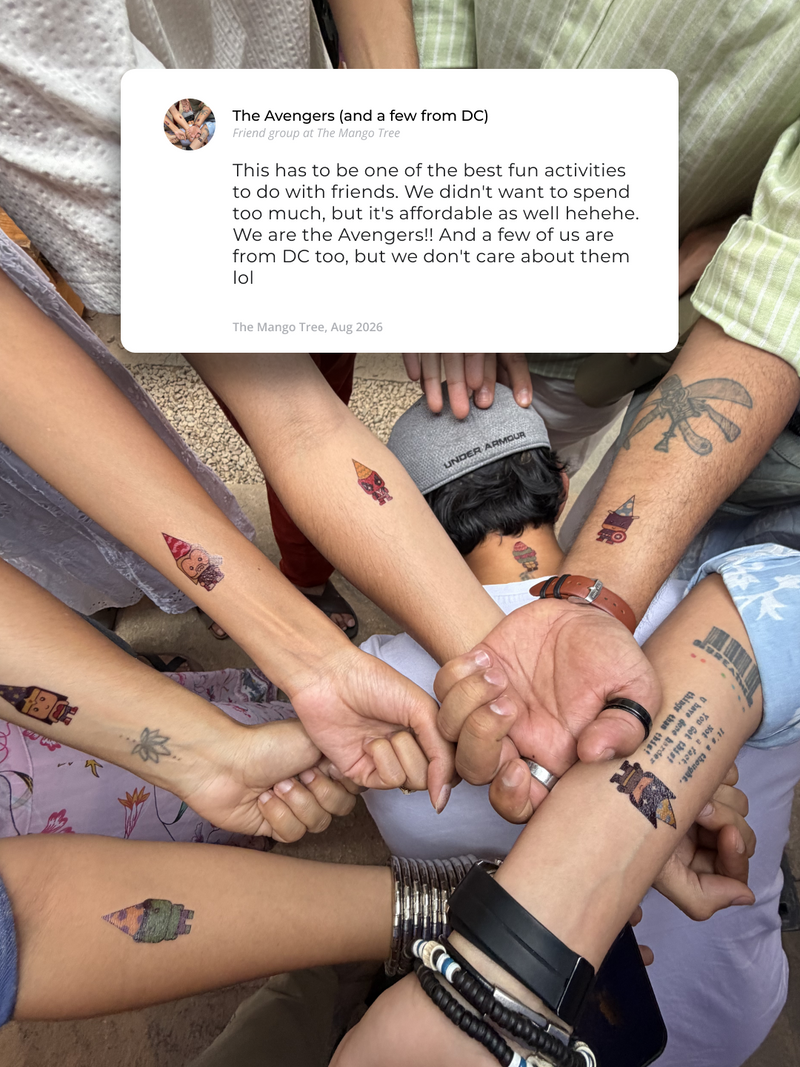 A group of friends at The Mango Tree showing their matching tattoos