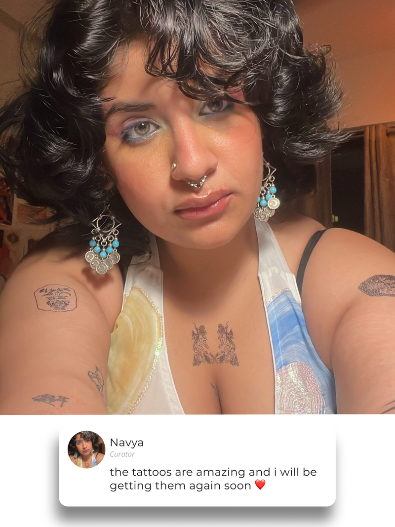 Navya wearing three tattoos on her arms and chest